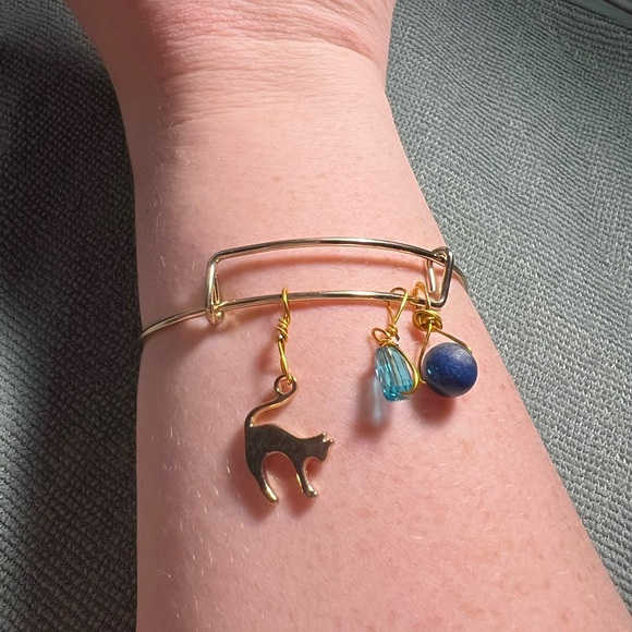 gold metal bracelet with cat, bead, & blue gemstone charms - Picture 3 of 5